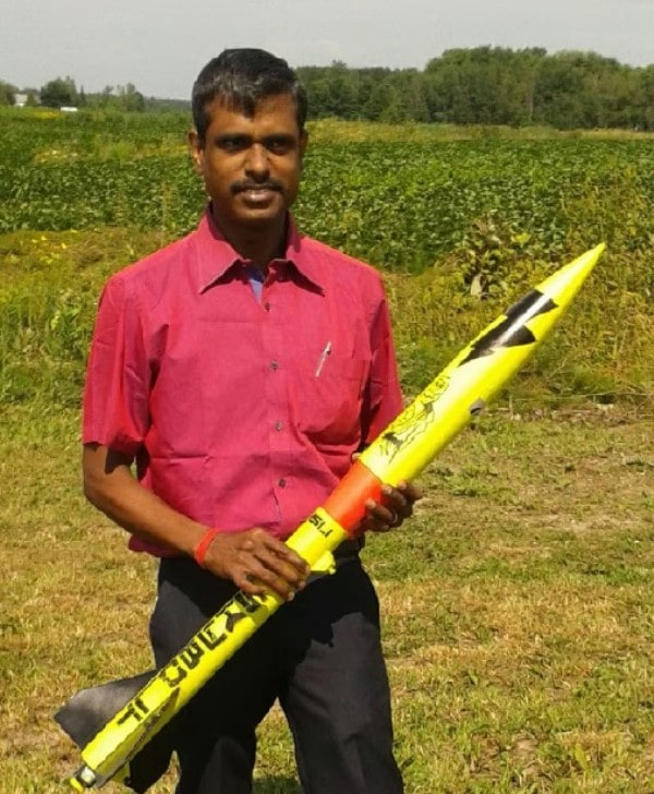 A photo of P. Veeramuthuvel with a rocket's model