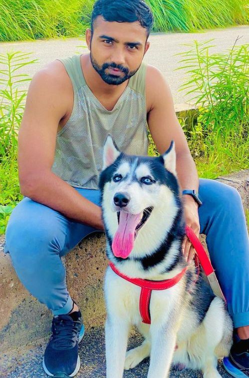 A picture of Monu Goyat with his Husky
