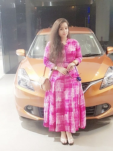 A picture of Nisha Pandey with her car