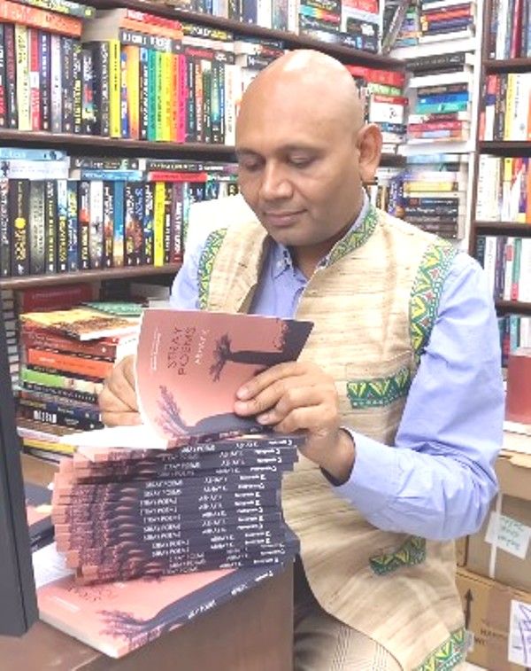 Abhay Kumar signing the book Stray Poems