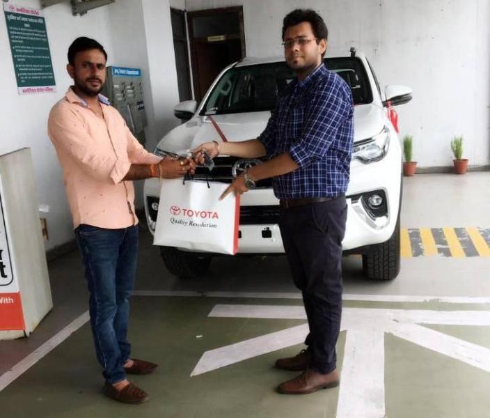 Anuj Chaudhary (left) buying his Toyota Fortuner SUV