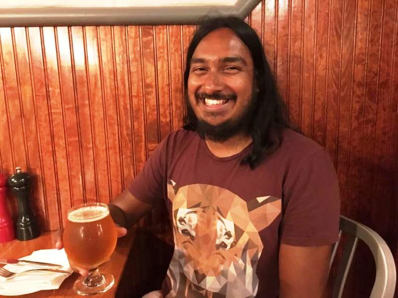 Bharat Sundaresan enjoying a glass of beer at Dogfish Head Brewpub