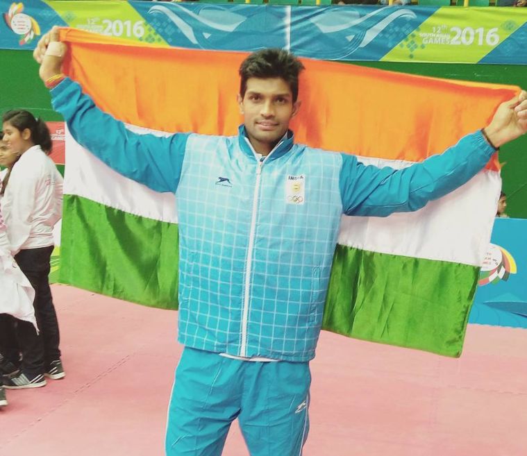 Deepak holding the Indian flag after winning South Asian Games 2016