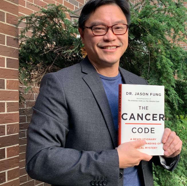 Dr Jason Fung posing with his book 'The Cancer Code'