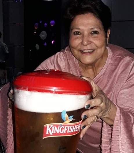 Jennifer Paes posing with a jar of beer