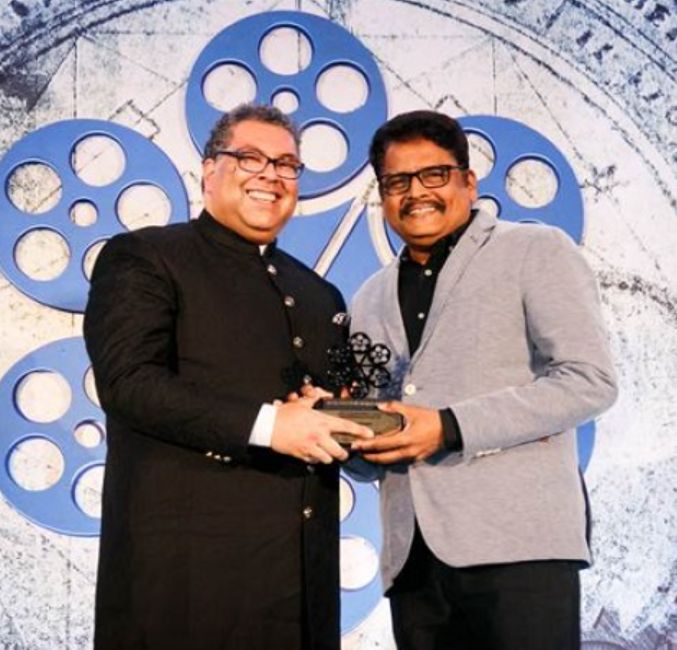 K. S. Ravikumar receiving the IIFTC Tourism Impact Award for Outstanding Contribution 2020