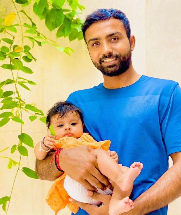 Monu Goyat holding his daughter