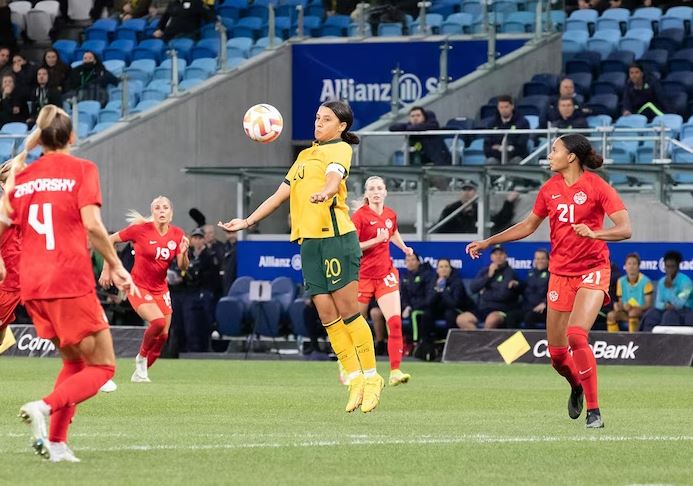 Sam Kerr (in yellow) during a match for Australia