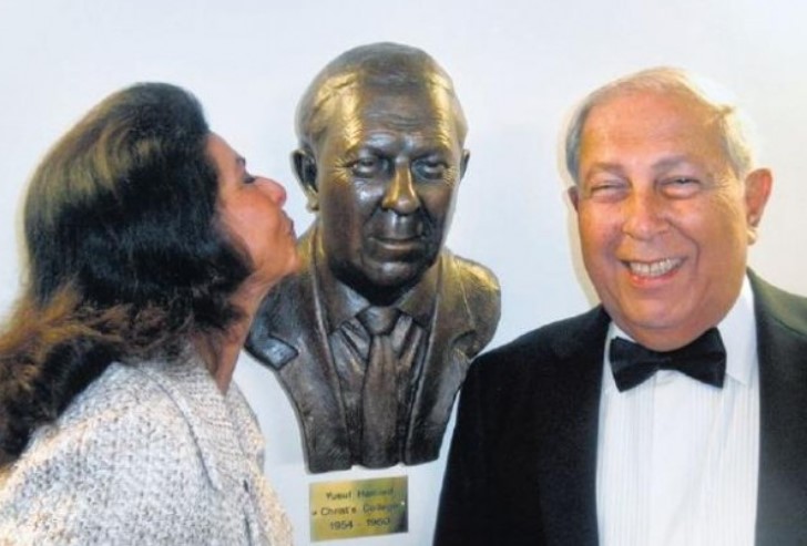 Yusuf's wife Farida while kissing her husband's statue