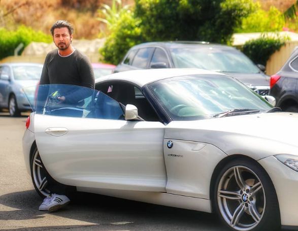 Afran Nisho with his BMW car