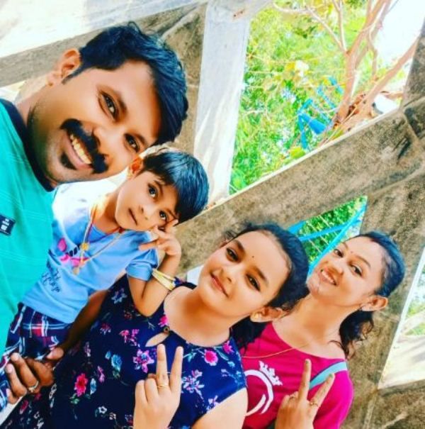 Aparna P Nair with her husband and daughters
