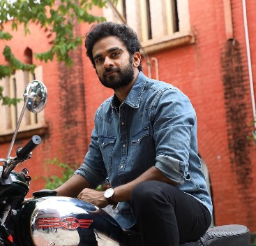 Ashok Selvan posing with his bike