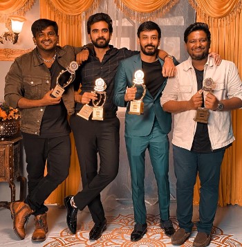 Ashok Selvan posing with the Best Actor award for the film 'Oh My Kadavule'