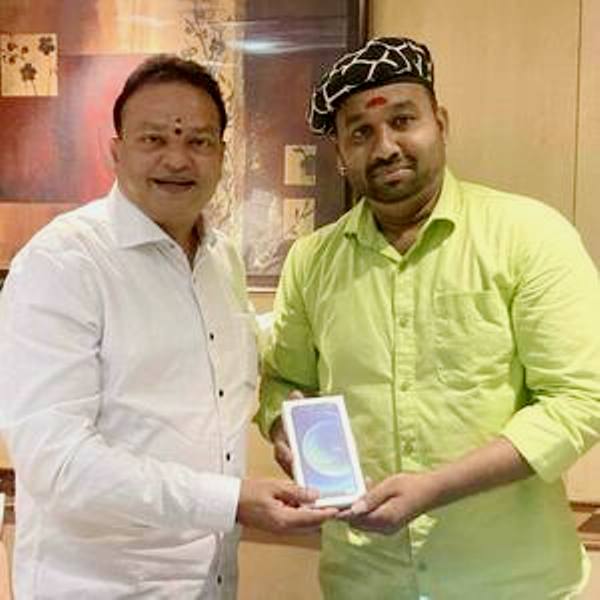 Cool Suresh while receiving an iPhone from Ishari K. Ganesh