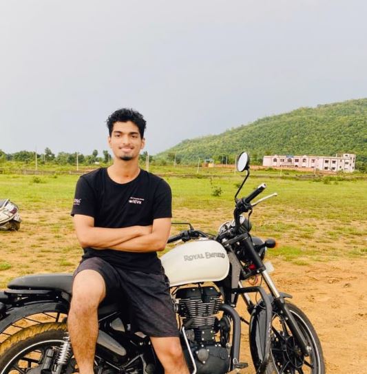 Debansu Rayaguru posing with his bike