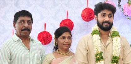 A picture of Vineeth Sreenivasan's father, mother, and brother