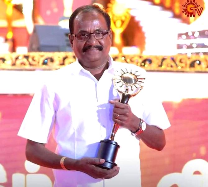 G. Marimuthu posing with an award