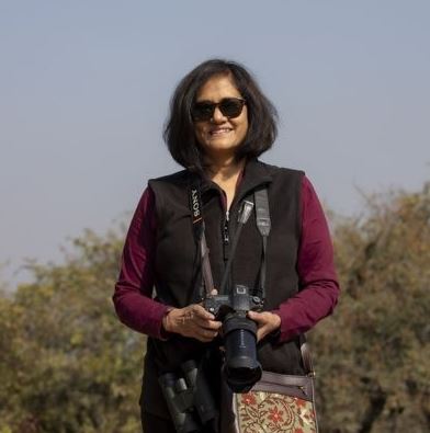 Jaya Verma Sinha posing with a camera