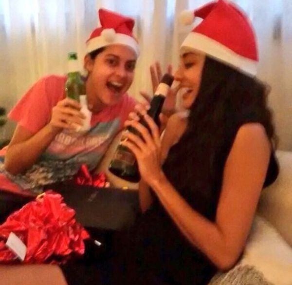Lisa Haydon (right) drinking alcohol at a Christmas party
