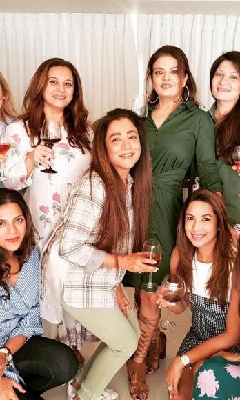 Manasi (extreme left) with a glass of wine