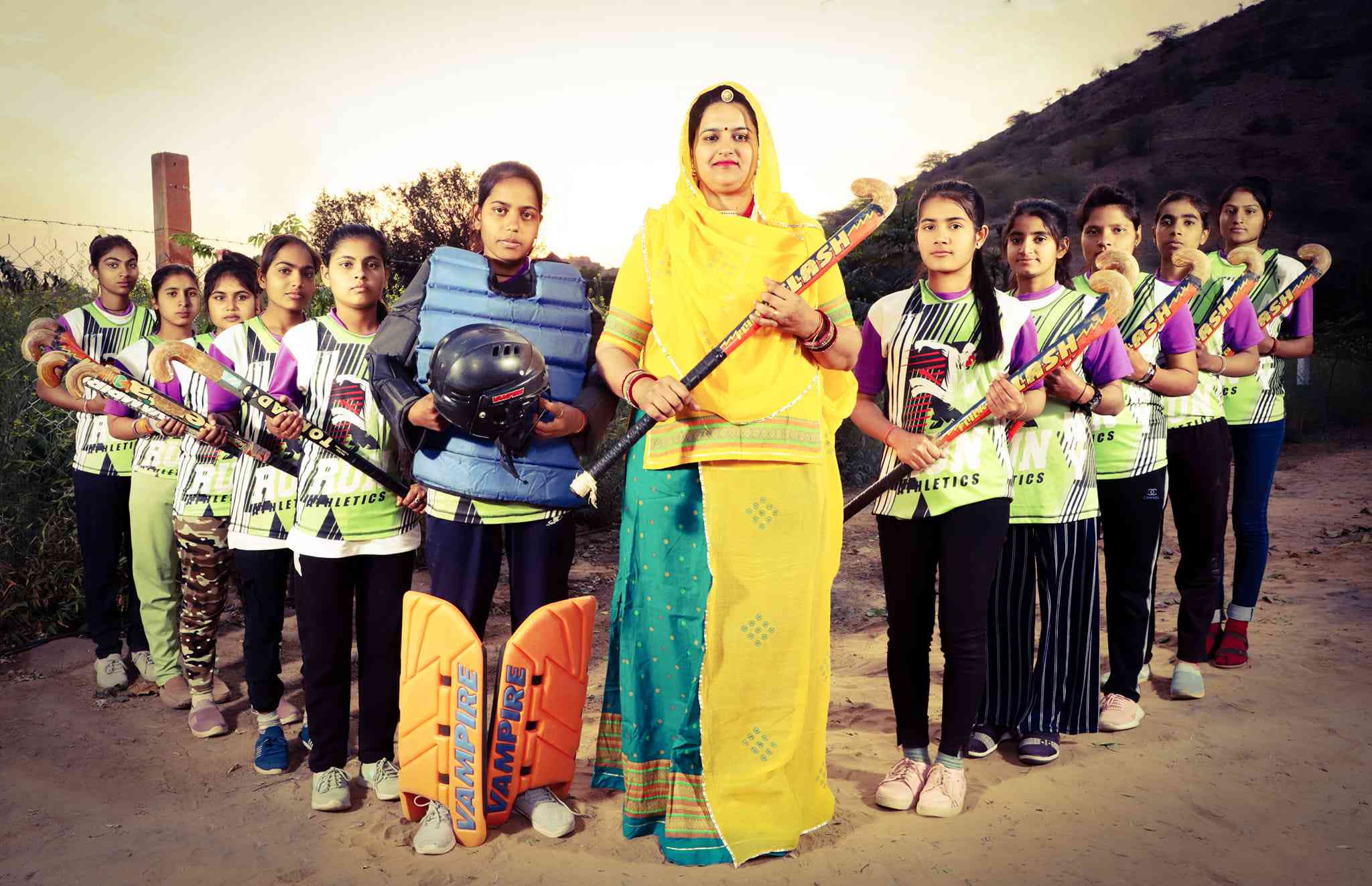 Neeru Yadav with girl's hockey team of her village