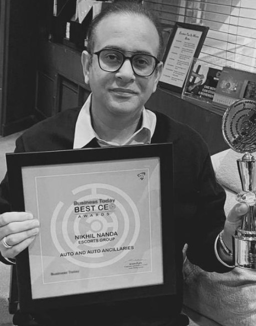 Nikhil Nanda posing with his Best CEO award (2021)