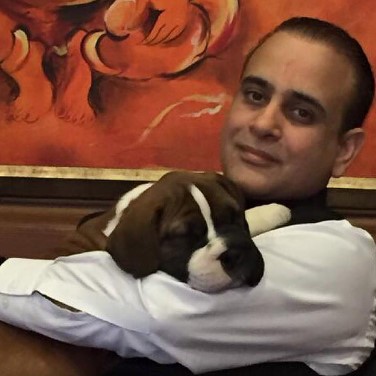Nikhil Nanda posing with his pet dog