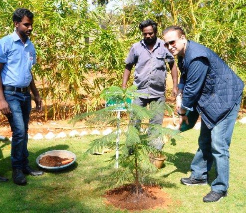 Nikhil Nanda while planting a tree