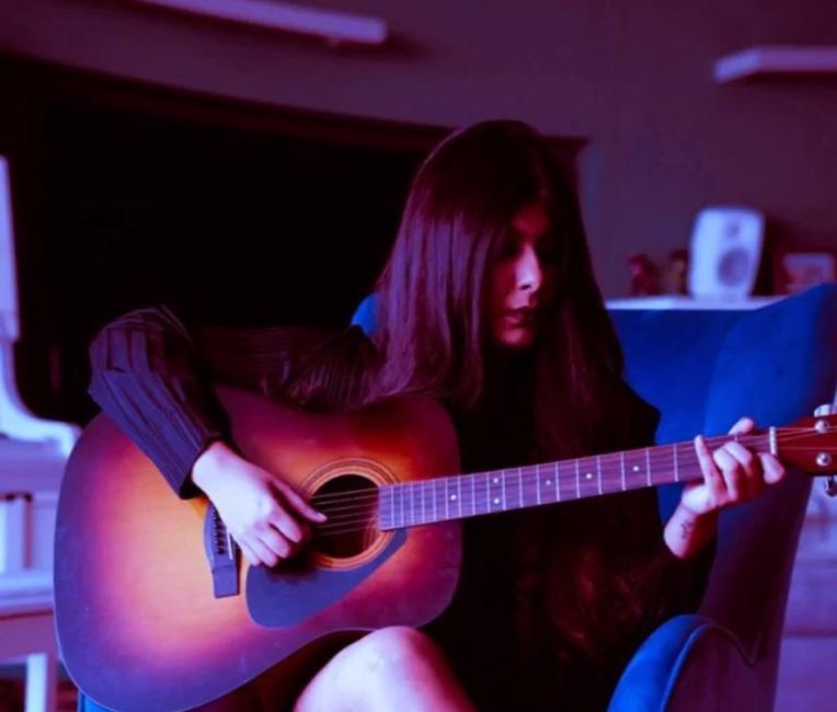 Priya Agarwal, who is a music producer, playing the guitar