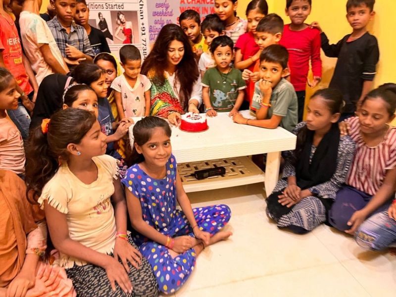 Rasha Kirmani (cutting cake) with the Children from NGO