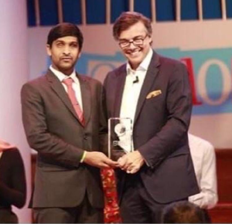 Srikanth Bolla (left) receiving Entrepreneur of the Year by One Young World