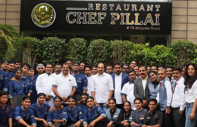 Suresh Pillai posing with his staff at Restuarant Chef Pillai