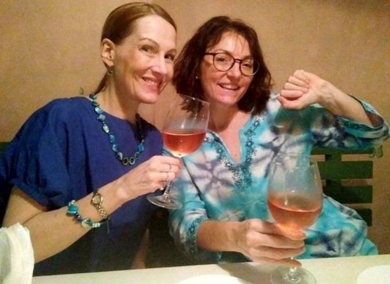Suzanne Bernert holding a glass of wine