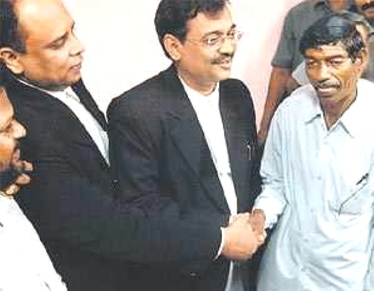 Ujjwal Nikam shaking hands with Bhaiyyalal Bhotmange, the lone survivor of the Dalit family, after winning the case