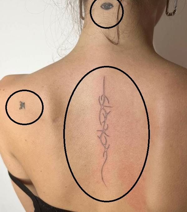 Vittoria Ceretti's thunder tattoo on her nape, spine, and left shoulder