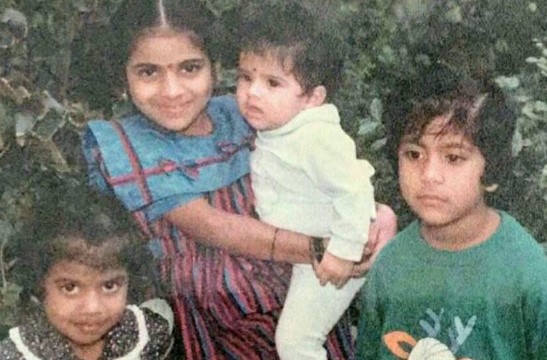 A childhood picture of Maya S. Krishnan in white dress with her sisters