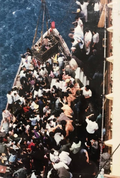 A packed boat being rescued by British sailors of the SS Sibonga on 21 May 1979
