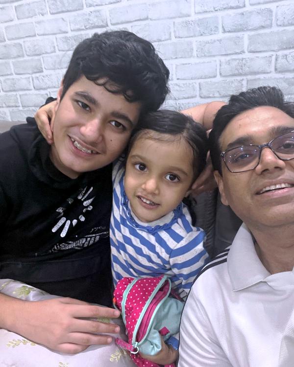 A photo of Manoj Kumar Sharma with his son and daughter