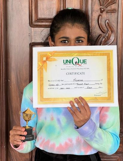 Alhena ADS posing with her Talent Hunt trophy and certificate