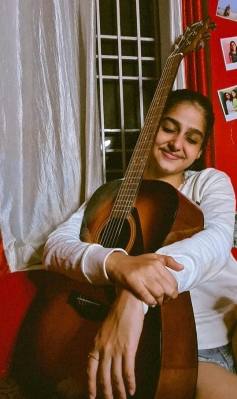 Anaswara Rajan with a guitar
