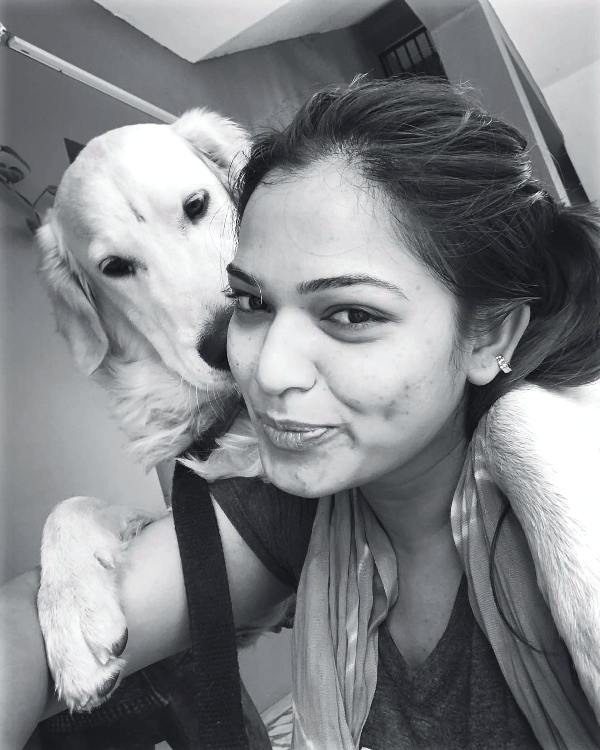 Ashwini posing for a photo with her pet