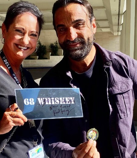 Fahim Fazli while showing his challenge coin from "68 Whiskey"