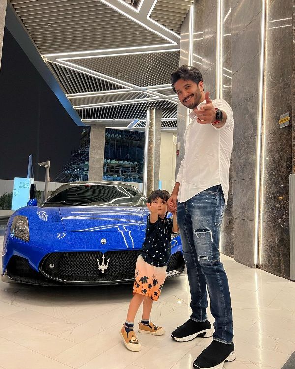 Feroze Khan posing with his car and son