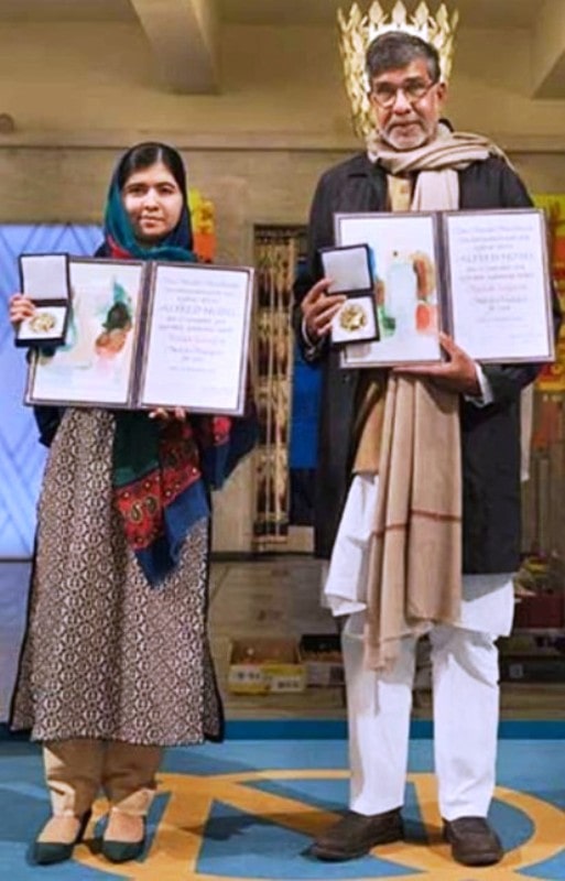 Kailash with Malala Yousafzai holding his Nobel Peace Price that he won in 2014