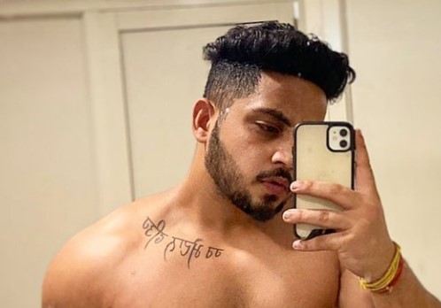 Karan Dutta featuring a tattoo on his collarbone