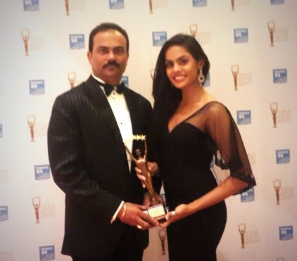 Karthika Nair posing with her father after winning an award for their UDS Group