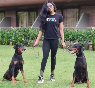 Karthika Nair posing with her pet dogs