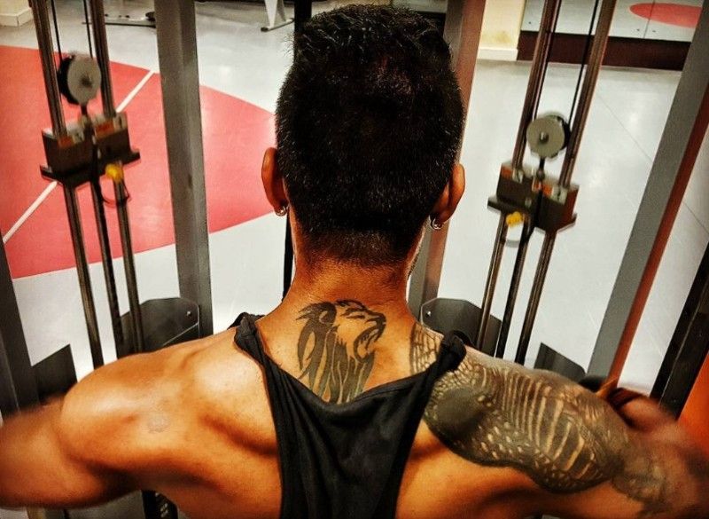 Lion tattoo on the back of Vinay Gowda's neck