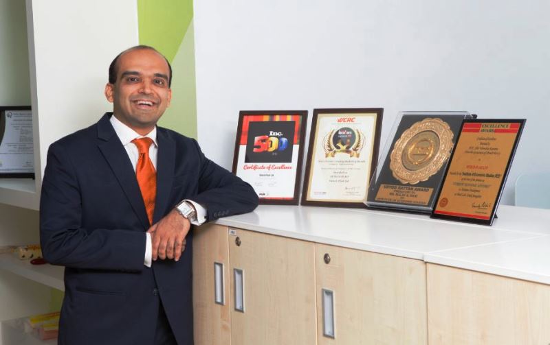 Malav Dani posing with the awards Hitech received under his leadership