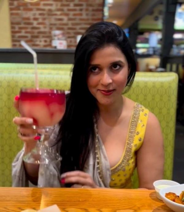 Mannara Chopra while holding a glass of Sangria Margarita